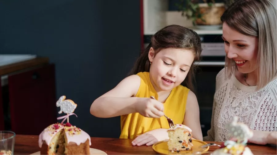 Woman and child eating cake