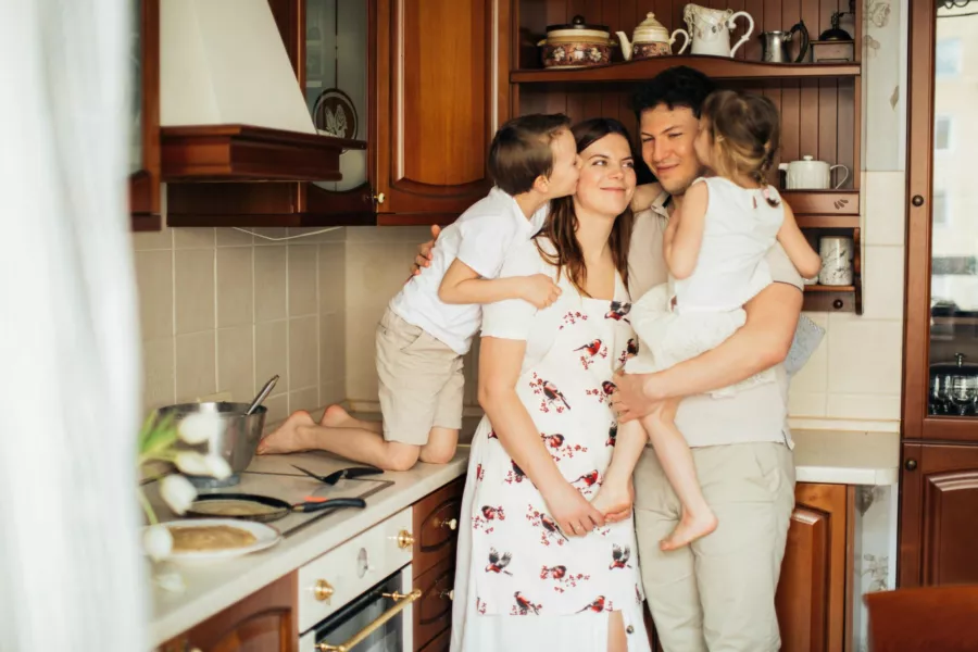 Young family gathered in a kitchen